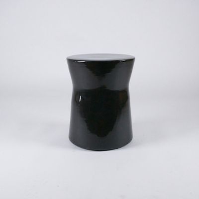 a black stool sitting on top of a white surface
