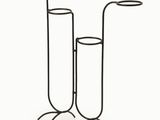 pair of black metal candlesticks on stand on a white background