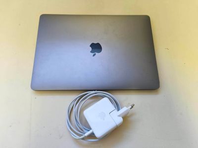 un ordinateur portable MacBook Pro d'Apple avec un chargeur et un câble