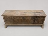 an old wooden chest sitting on top of a table