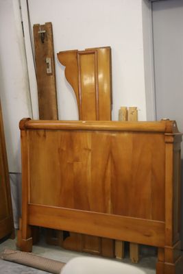 a bed with a wooden headboard and foot board in a room