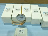 a clock that is sitting on a table next to some boxes