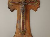 wooden cross hanging on the wall with a crucifix on it