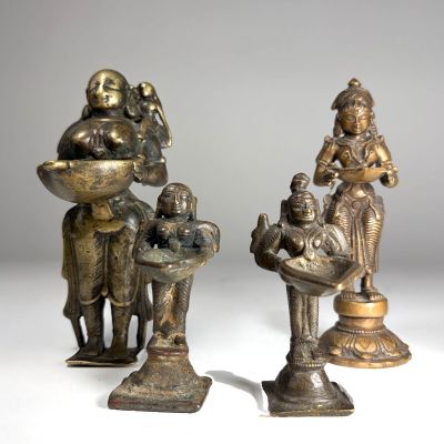 deux figurines en bronze représentant un homme et une femme avec un bébé