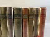books are lined up in a row on a white surface