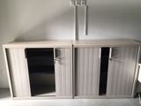 a white cabinet with two doors and a shelf on top of it