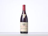a bottle of red wine sitting on top of a table