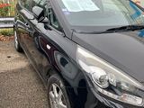 a picture of a black car parked in front of a truck