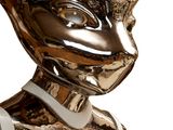 a silver statue of a woman with a hat on