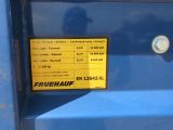a sign on the side of a blue dump truck