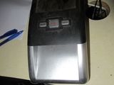 a toaster sitting on a table next to a pen and paper