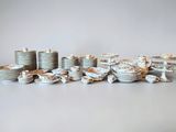 a lot of plates and cups that are sitting on a table