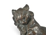 a statue of a cat that is sitting on the ground