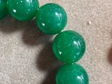a close up of a bracelet with beads on a table
