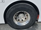 a white bus that is parked on the side of the road