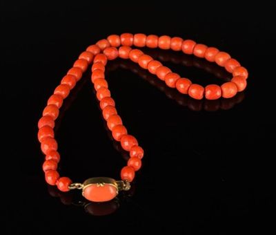 an orange jade bead necklace with a gold clasp
