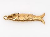 an image of a gold fish pendant on a white background