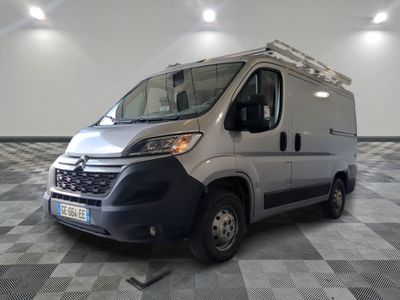 the silver van is parked on a checkered floor in a room