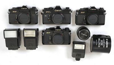 many cameras that are sitting on a white surface