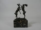 statue of two deers on a marble base on a white background