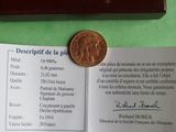 a picture of a piece of paper with a coin on top of it