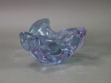 purple and blue glass bowl sitting on top of a table