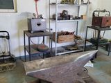 a blacksmith ' s workshop with an anvil on the table