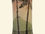 a vase that has a picture of trees on it