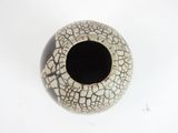 a white vase with a cracky design on it