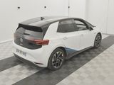 the rear end of a white car parked in a garage