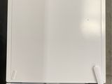 a picture of a white refrigerator freezer sitting on a tiled floor