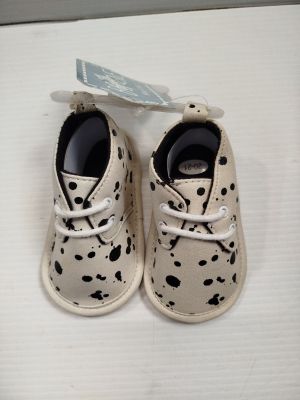 a pair of baby shoes with spots on them