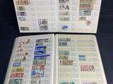 an open book with stamps on it sitting on a table