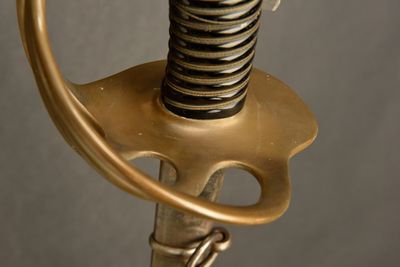 a close up of a sword with a metal handle