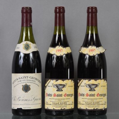 three bottles of wine are lined up on a table
