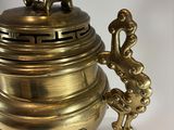 an image of a brass urn with a lion on top of it