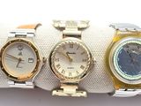 three watches are sitting on a napkin on a white surface