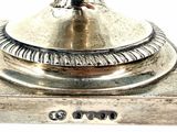 a silver plate with a bird on top of it