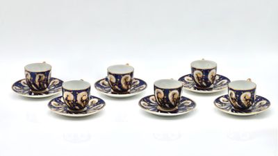 six blue and white cups and saucers sitting on top of each other
