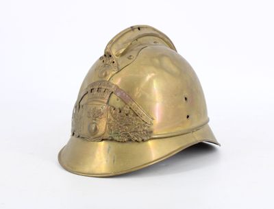 a gold helmet that is sitting on a white surface