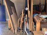 several pieces of wood are stacked on top of a cart in a garage