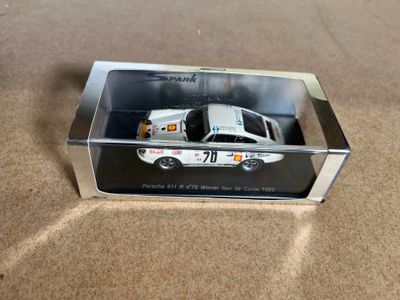 a toy car in a clear box on the floor