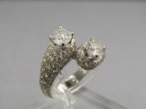 an image of two diamond rings sitting on top of a clear surface