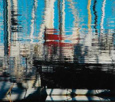 a boat that is sitting in the water with its reflection on the water
