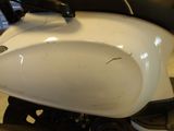 a close up of a white motorcycle with a black seat