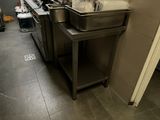 une cuisine avec un évier et un comptoir sur lequel sont posés de nombreux ustensiles
