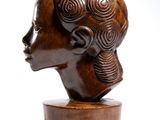 sculpture of a woman ' s head on a wooden stand