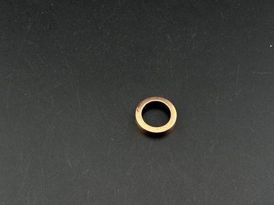 a close up of a metal ring on a black surface