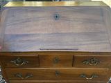 an old wooden desk with drawers and drawers on top of it