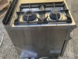a gas stove that is sitting on the ground